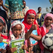 Image of Ethiopian school children receiving learning materials.