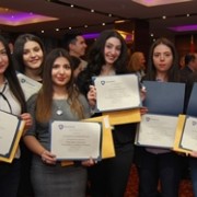 young women with certificates of course completion