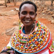 Nalan'gu Lokoloto wearing some of the colorful traditional jewelry helping her make a living.