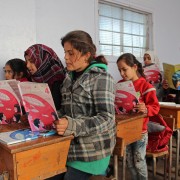 Syrian children attend class in a classroom at a school which was hit by bombardment in the district of Jisr al-Shughur, in the west of the mostly rebel-held Idlib province, on January 30, 2019. (PHOTO BY IBRAHIM YASOUF / AFP)