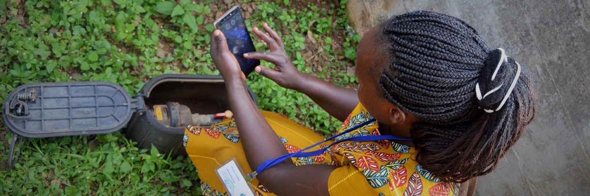 A meter reader with the Kakamega County Water and Sanitation Company checks a consumer’s water point. Photo credit: Euphresia Luseka/KIWASH 