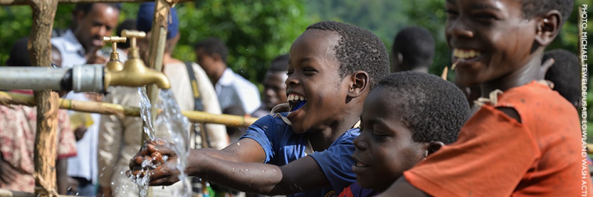 Image of Ethiopian boys accessing clean drinking water.