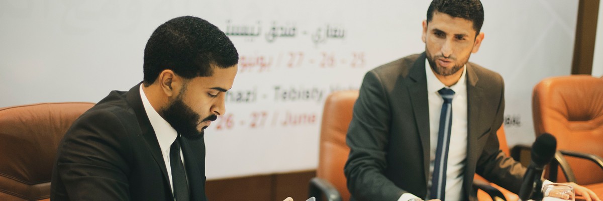 Libyan men converse together during a Civil Society and Local Development event.