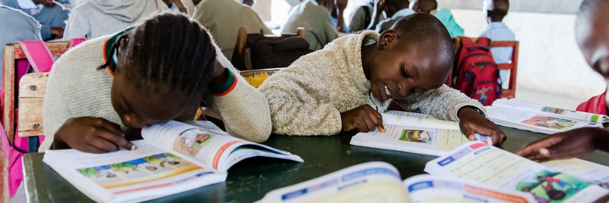 Grade 1 pupils at Obinju Kanyakwar Primary School enjoy reading colorful books that engage their intellect and imagination. RTI/USAID