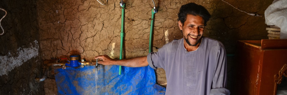 A man runs water from a new faucet in his house.