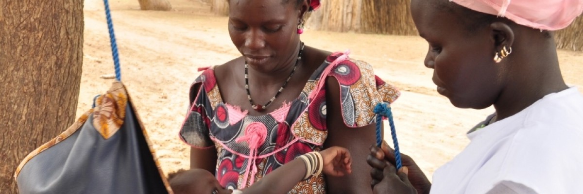 Mbène Dionne weighs village babies to ensure they are not underweight