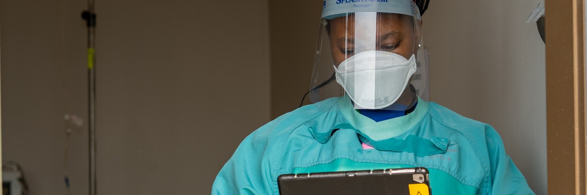 A healthcare worker at TLC using a customized, locally-hosted electronic medical record (EMR) system. The TLC medical team tracks care for every patient. New COVID-specific modules in the EMR provide support for COVID-19 screening and contact tracing. 